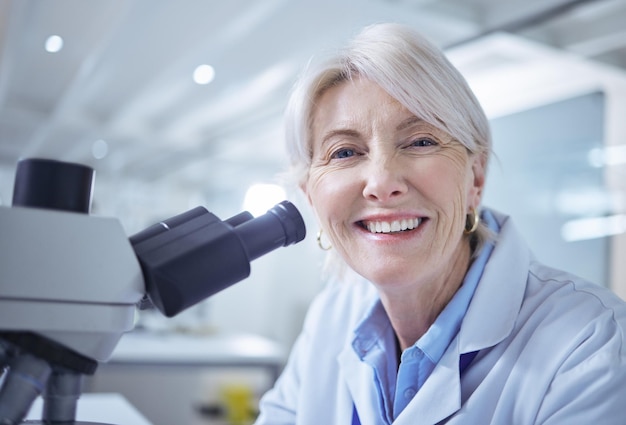 mature scientist portrait and medical research in chemistry lab for science experiment in pharmaceutical female person microscope and smile for pathology test analysis and mpox vaccine in denmark