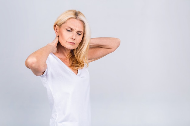 Mature senior old beautiful woman wearing casual suffering from back pain. Empty blank copy space with backache concept. Isolated over white grey background