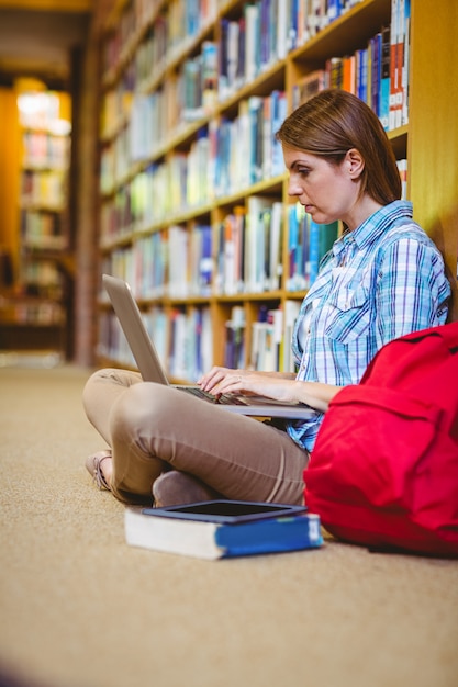 Mature student in the library using laptop