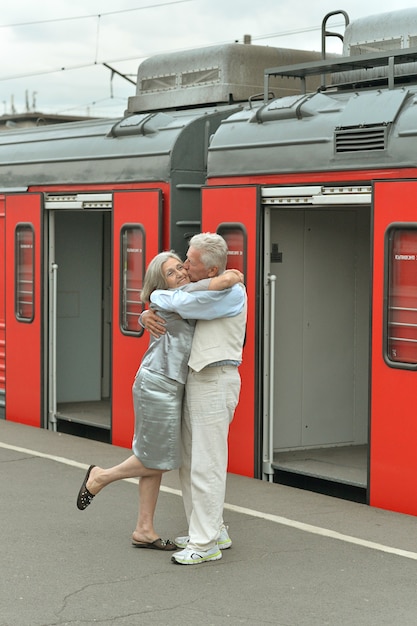 Mature vital elderly couple at the train station