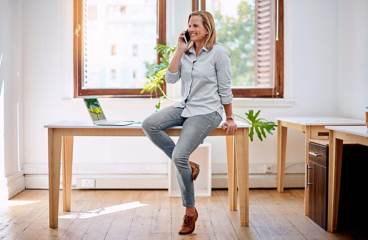 Photo mature woman business owner and office with phone call planning or discussion with idea for project web creative designer and communication with smartphone entrepreneur and company negotiation