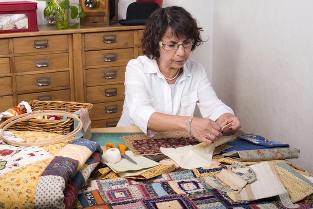 Mature woman by sewing and quilting