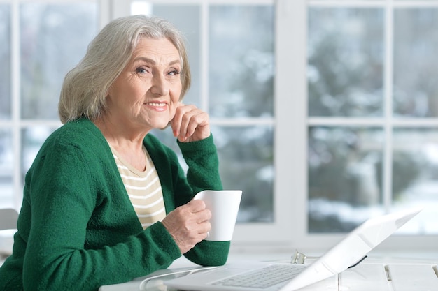 Mature woman in cafe, sitting near window