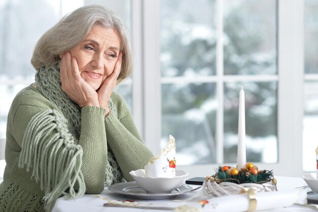 Mature woman in cafe, sitting near window