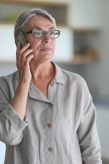 Mature woman calling on the phone in the office