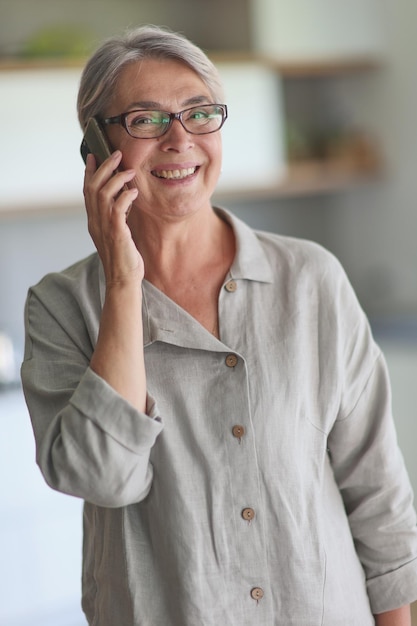 Mature woman calling on the phone in the office