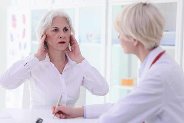 Mature woman complains on acute headache in light office