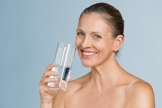 Mature woman drinking water