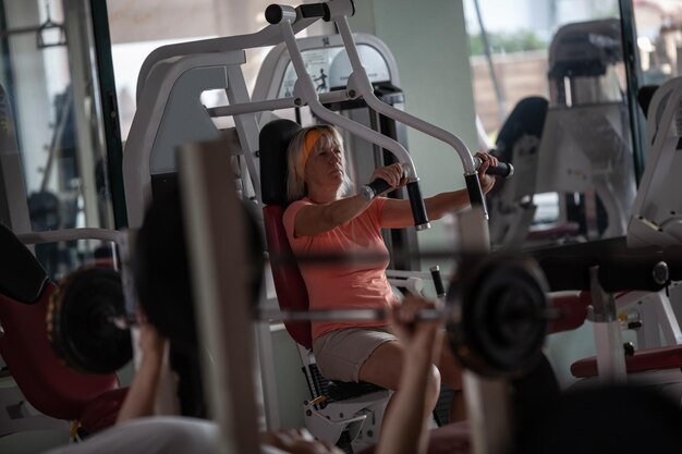 Mature woman exercising in gym