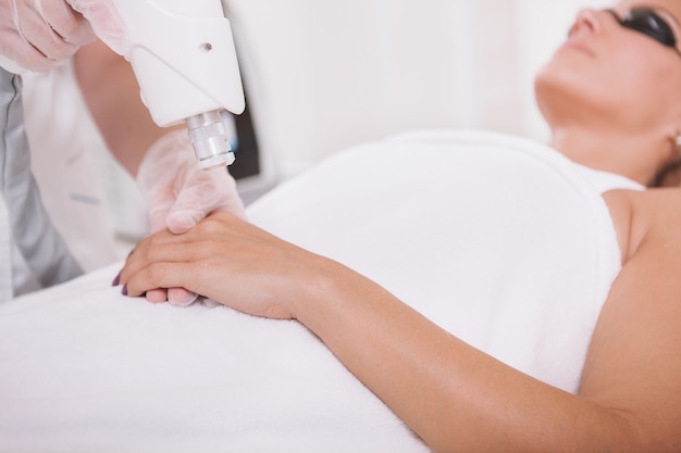 Mature woman getting skincare treatment at beauty salon