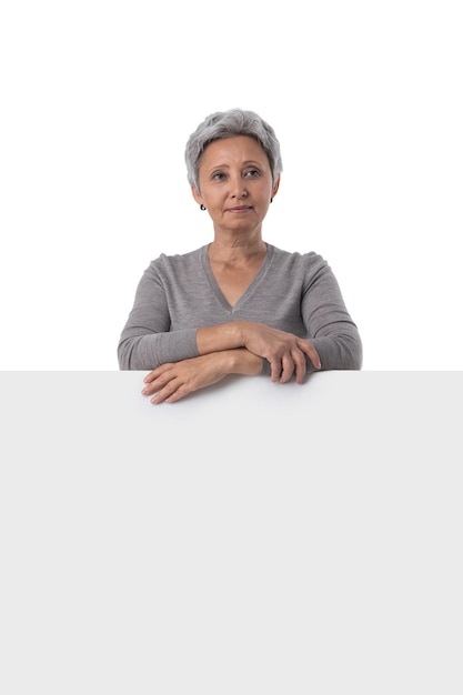 Mature woman holding empty text board