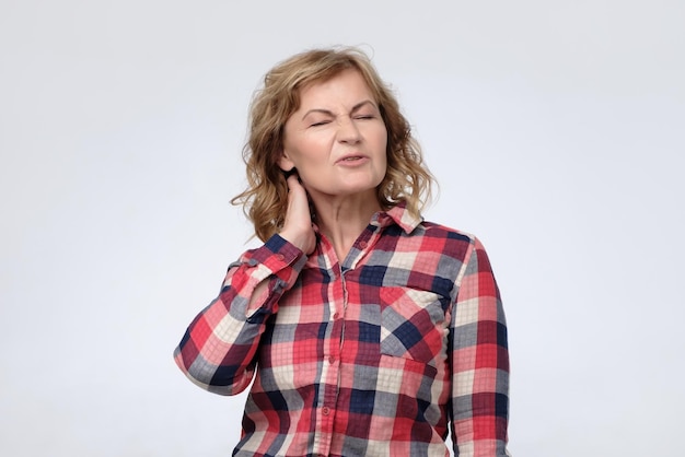 Mature woman is having pain in her neck