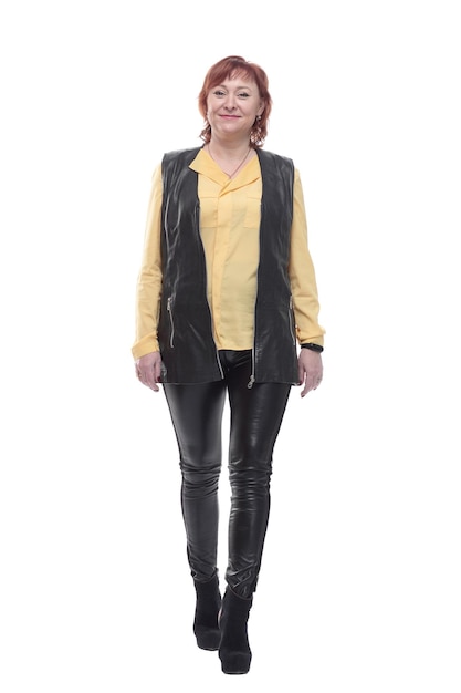 Mature woman in leather trousers striding forward