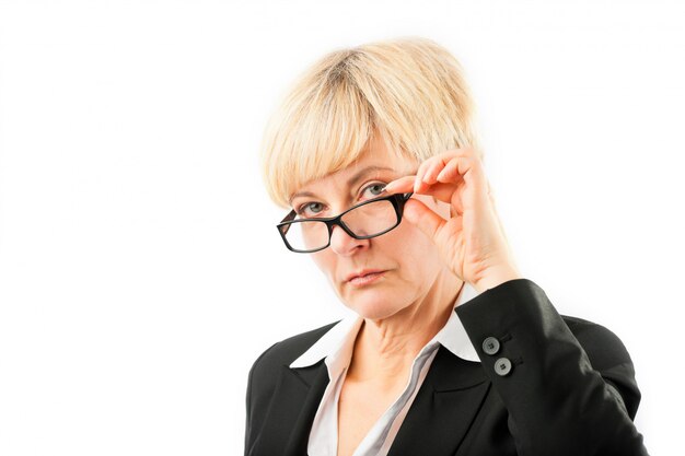 Mature woman looking through her glasses