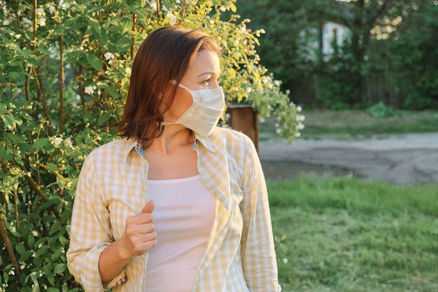 Mature woman in medical mask, allergy season