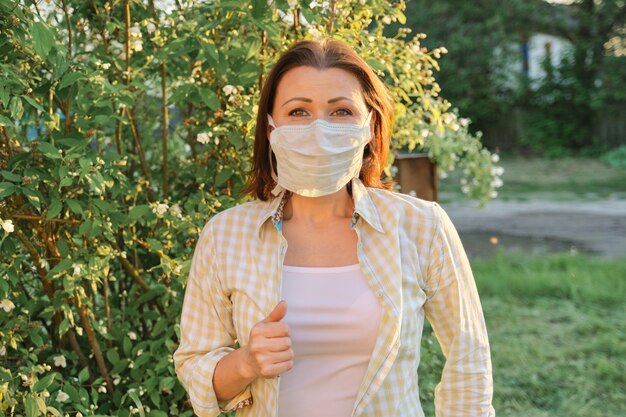 Mature woman in protective medical mask, female outdoor