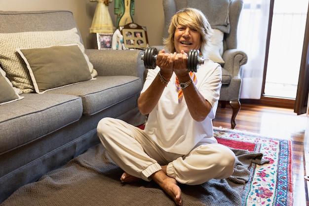 Mature woman smiling doing strength training at home