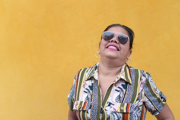 Mature Woman Standing Against Wall