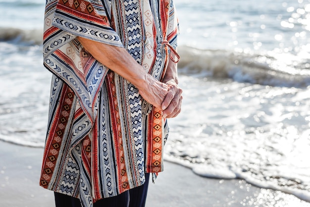 Mature woman standing at the beach