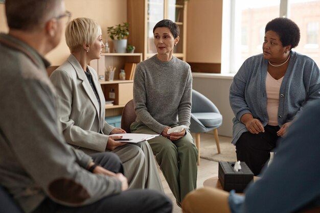 Mature woman talking to female psychologist