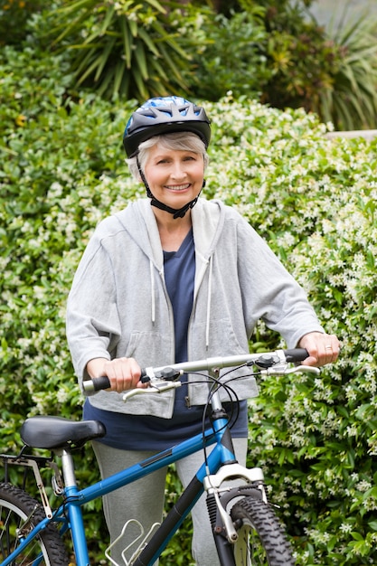 Mature woman walking with her mountain bike