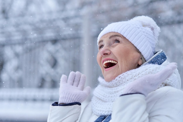 Mature woman in winter clothes posing outdoors