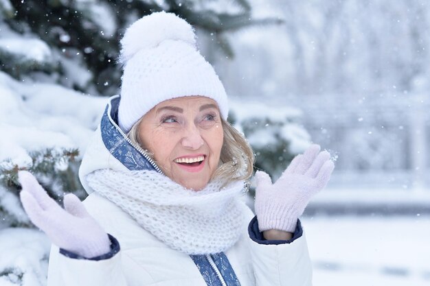 Mature woman in winter clothes posing outdoors