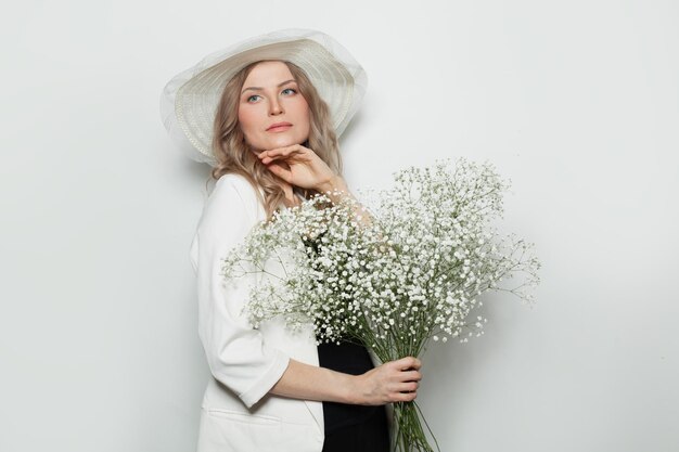 Mature woman with flowers on white background