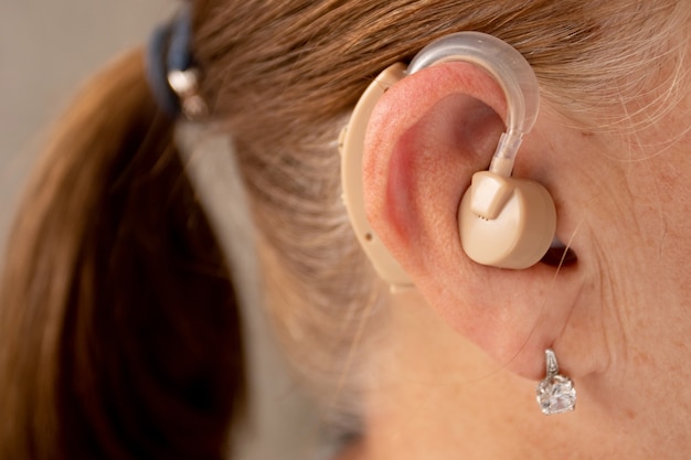 Mature woman with hearing aid.
