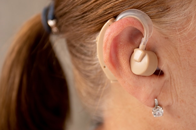 Mature woman with hearing aid.