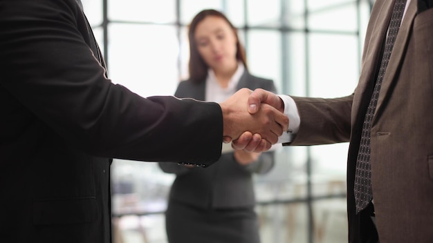 Mature workers shaking hands in partnership deal collaboration