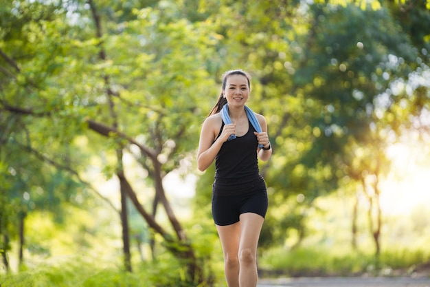 A matured Asian woman jogging exercise in the city park