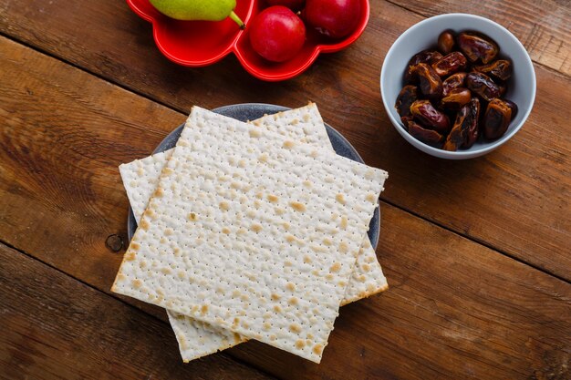 Foto matze en vers fruit met dadels op een houten tafel