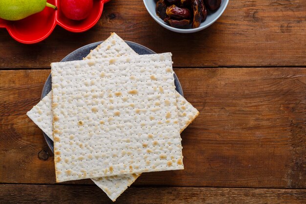 Matzo and fresh fruits with dates on a wooden table