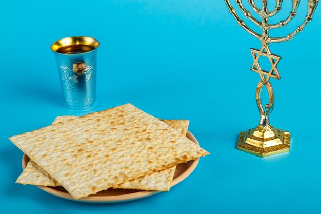 Foto matzo-platen uitgelegd door magen dovid op een blauwe achtergrond en een glas wijn