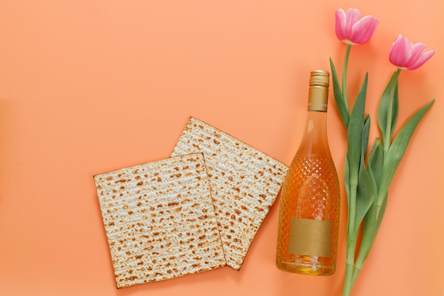 Matzo with tulips flowers and a bottle of wine Pesach celebration concept jewish Passover holiday