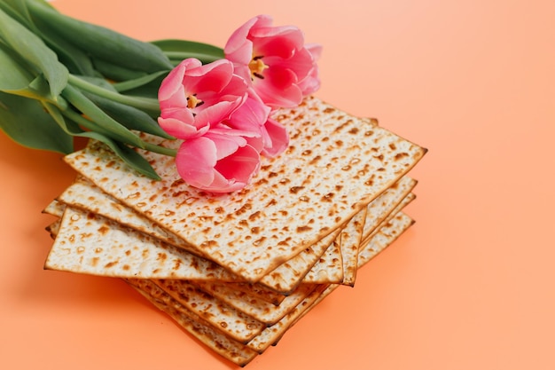 Matzo with tulips flowers Pesach celebration concept jewish Passover holiday