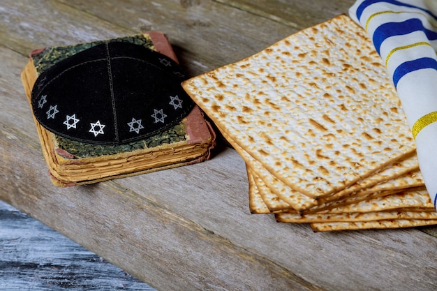 Matzoh for jewish holiday Passover pesah on wooden background.