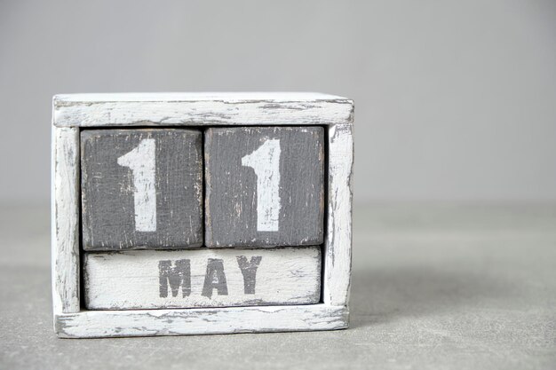 May 11 calendar made wooden cubes gray backgroundWith an empty space for your text