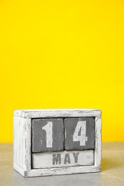 May 14 calendar made wooden cubes yellow backgroundWith an empty space for your text