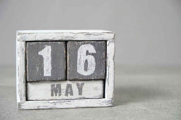 May 16 calendar made wooden cubes gray backgroundWith an empty space for your text