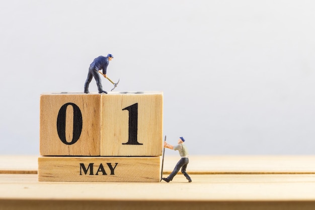 May 1st Day 1 of month Miniature worker wooden block calendar labor day's concept