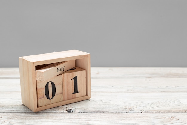 May 1st. Image of may 1 wooden color calendar on wooden table. Spring day, empty space for text. International Workers' Day