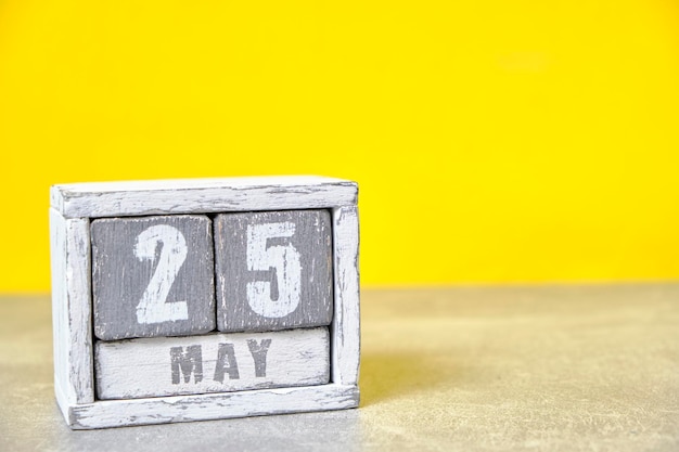 May 25 calendar made wooden cubes yellow backgroundwith an empty space for your text