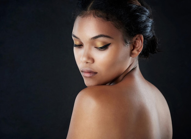 May the wings of your eyeliner always be even Shot of a beautiful woman posing against a black background