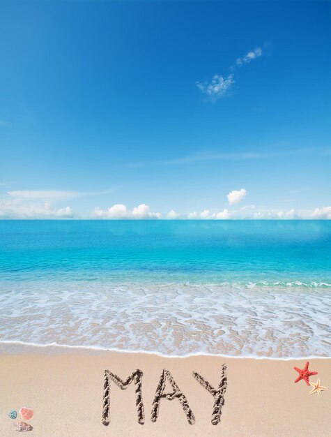 May written on a tropical beach under clouds