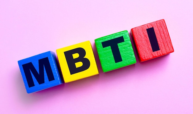 MBTI acronym word on wood blocks on desk with books Psychological study and research concept