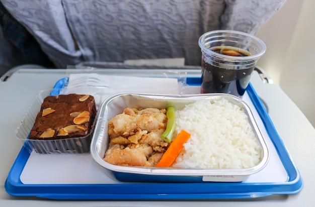 Meal serve on airplane with bakery and soft drink