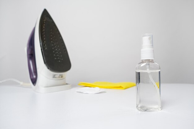 Means for cleaning the iron in a bottle on a white background