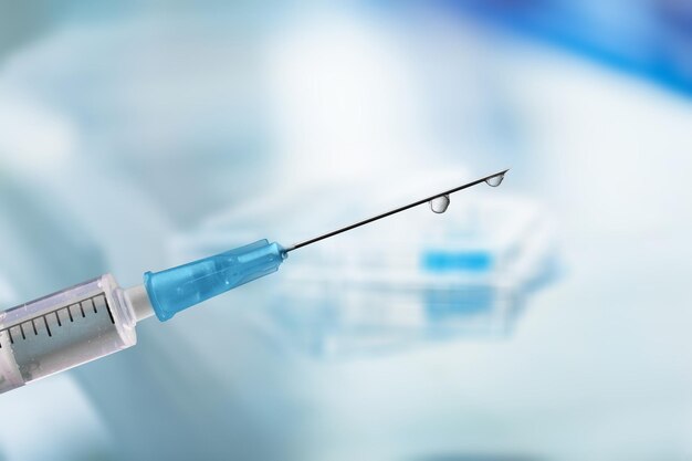 measles vaccine shooting from a plastic syringe.